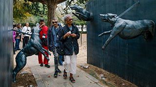 Visitors walk between sculptures of aggressive dogs representing 1963 police attacks on civil rights marchers in Birmingham, Alabama's Kelly Ingram Park.
