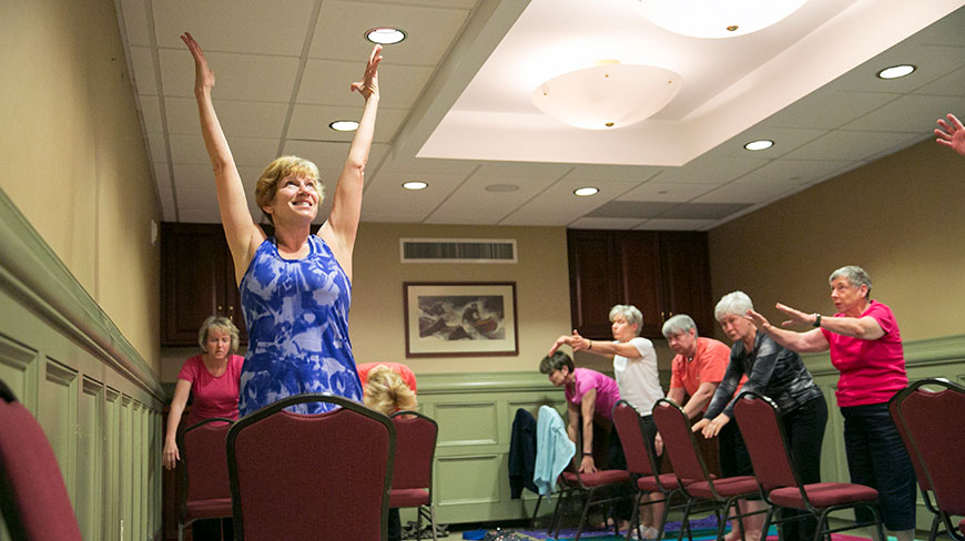A group of women stretch and do chair yoga during a women's adventure trip on the Appalachian Trail in Pennsylvania.