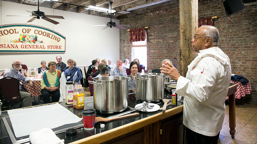 A chef leads a cooking class for a group of people at the Louisiana General Store in New Orleans.