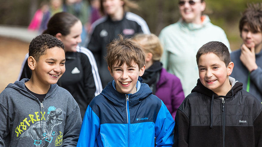 A group of smiling grandchildren on an outdoor adventure in Chincoteague, Virginia.