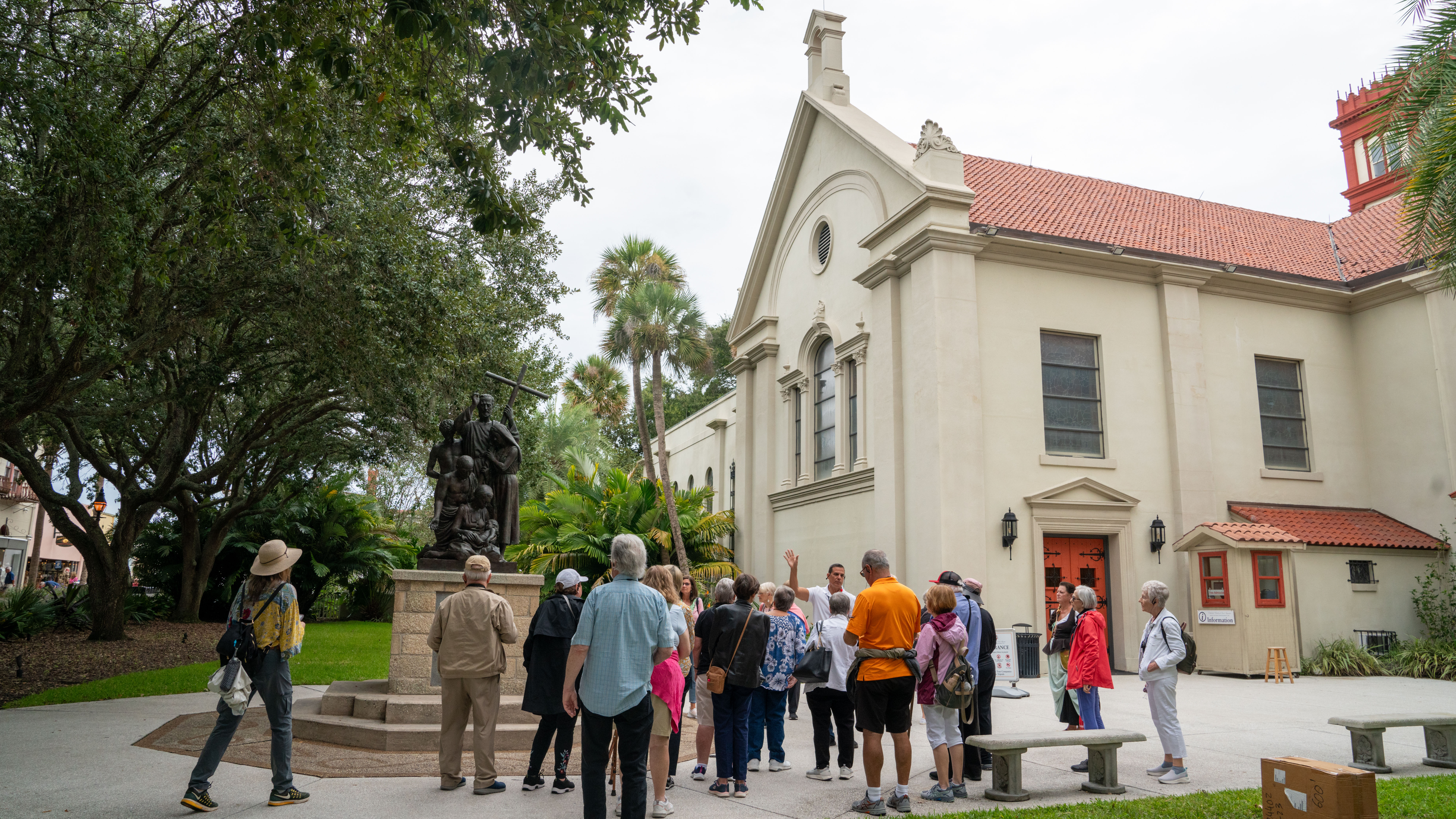 A tour group listens to a guide outside the Cathedral Basilica of St. Augustine in Florida.