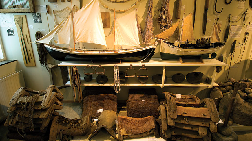 Model ships and historical fishing artifacts on display at the Skógar Museum in Iceland.