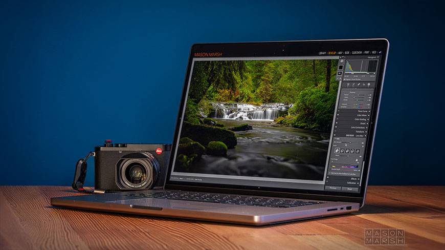A laptop displays an image of a waterfall in Ecuador being edited in Lightroom, with a digital camera sitting next to it.
